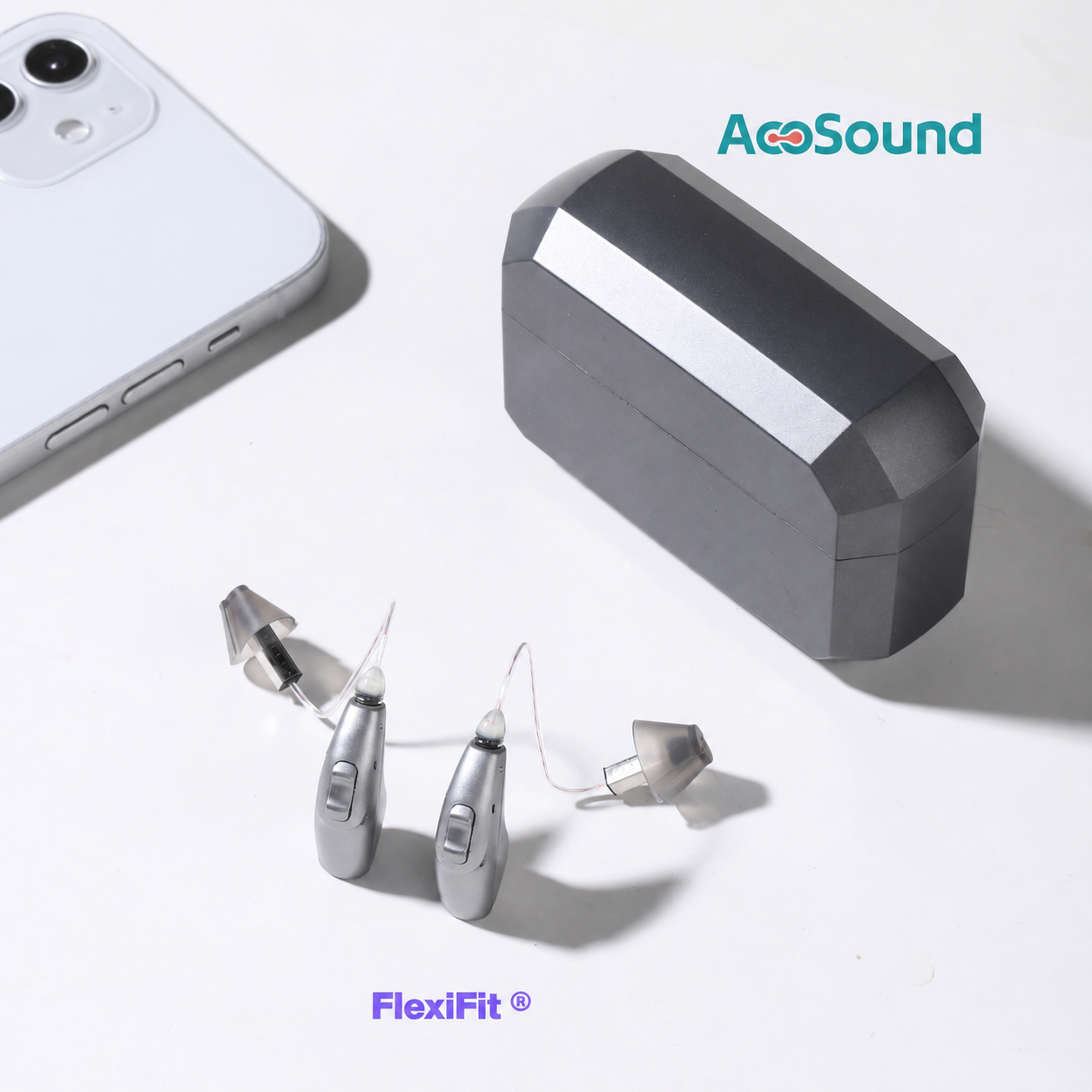 Dos audífonos Wave grises junto a un teléfono y su cargador