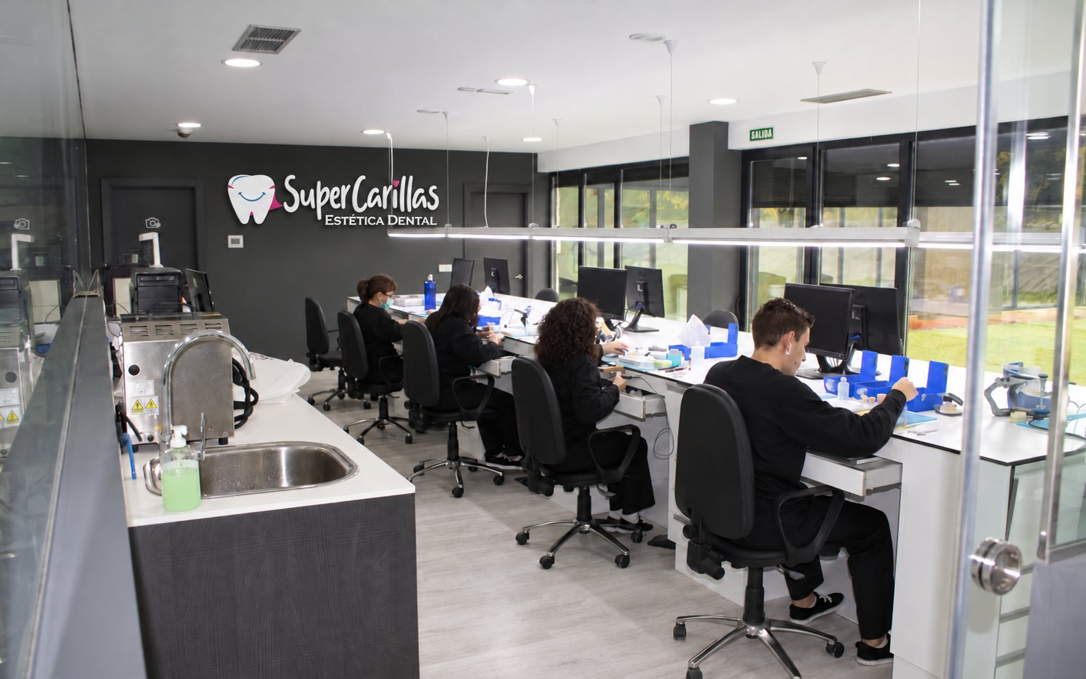 Edited illustrative image of a dental laboratory with workstations and SuperCarillas signage