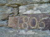The date 1806 carved into the stone of the lagar